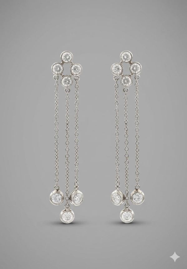 A PLATINUM AND DIAMOND EARRING SIGNED BY TIFFANY